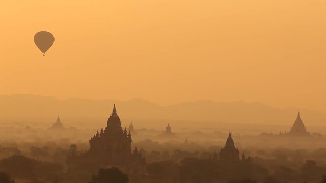 WS HA Hot-air balloon flying over ancient temples at sunrise / Bagan, Myanmar