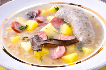 a polish easter soup with homemade white sausage and mushrooms