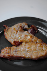 pork steak grilled with salad and tomato Shallow depth of field