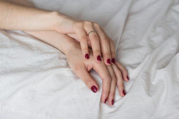 young woman lying in bed on white sheets