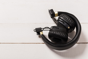 Headphones on white wooden background