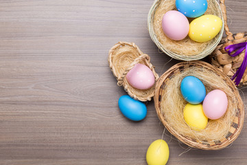 Easter eggs in the basket on wooden background