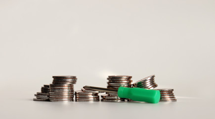 A mini screwdriver with a pile of coins.