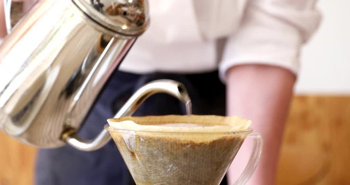 Barista pouring water on ground coffee in kono dripper : Hand Drip Coffee, Kono drip