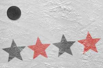 The image of black and red stars on ice with hockey puck
