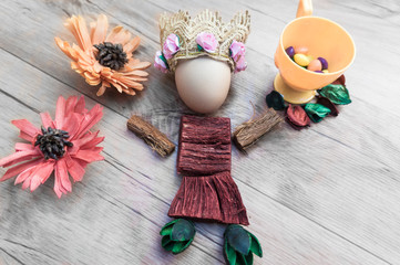 Easter, preparation for Easter, still life, story for Easter, eggs, colored objects, flowers, wooden background, wreath,