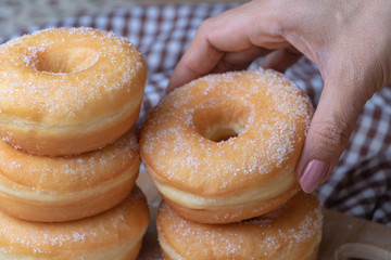 Sugar donuts on wooden board