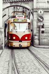 red vintage tram in the old streets of Prague