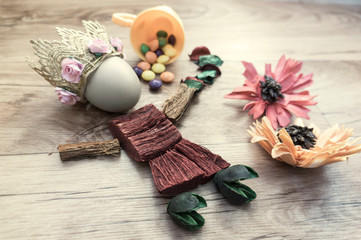 Easter, preparation for Easter, still life, story for Easter, eggs, colored objects, flowers, wooden background, wreath,