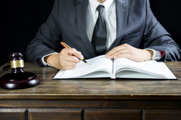 justice and law concept.Male judge in a courtroom working on wood table with documents., attorney court judge justice gavel legal legislation concept.