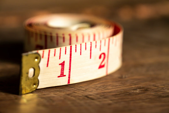  Tape measure on wood texture background, Close up & Macro shot, Selective focus