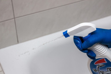 Close-up of the shower faucet and showerhead cleaning process from lime scale, white chalk sediment...