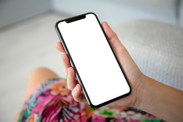 female hands in colored dress holding phone with isolated screen