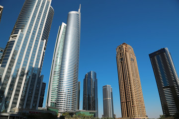 Fototapeta na wymiar Almas tower and Jumeirah Lakes Towers, Dubai Multi Commodities Centre, UAE
