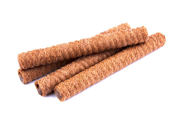 Waffle rolls with chocolate cream on white background