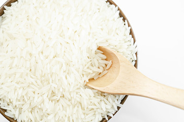 Raw white rice with wooden scoop.