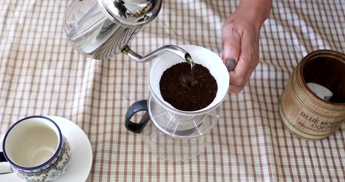 Barista pouring water on ground coffee in kono dripper : Hand Drip Coffee, Kono drip