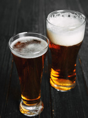 two Beers on a dark wooden table