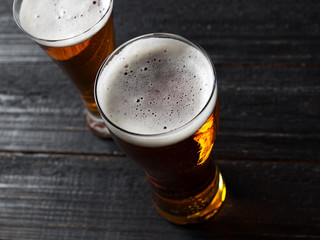 two Beers on a dark wooden table