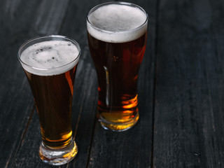 two Beers on a dark wooden table