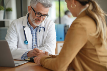 Woman having medical appointment with doctor in hospital