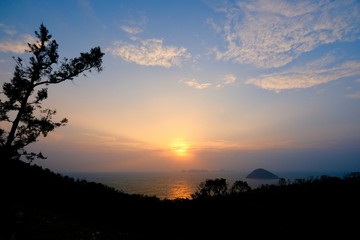 Beautiful sunrise image with colorful blue purple orange sky and white cloud with seascape landscape background