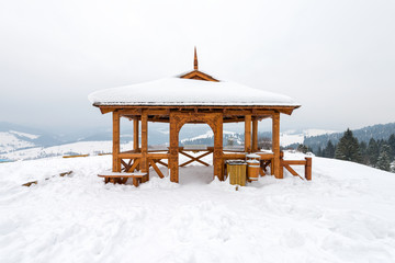 observation point in the Pieniny mountains - a traditional wooden gazebo covered with snow in winter
