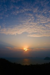 Beautiful sunrise image with colorful blue purple orange sky and white cloud with seascape landscape background