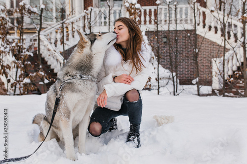 White Jacket Kissing Her Husky Dog 