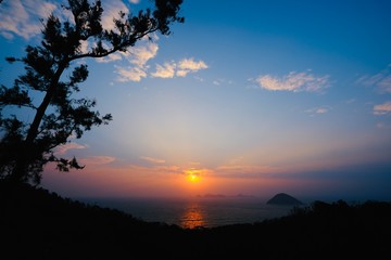 Obraz na płótnie Canvas Beautiful sunrise image with colorful blue purple orange sky and white cloud with seascape landscape background