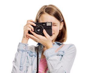 Teenager girl with a camera, close-up, isolated on white background