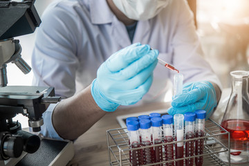 lab technician assistant analyzing a blood sample in test tube at laboratory. Medical,...