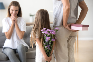 Loving daughter and grandmother preparing surprise for mother