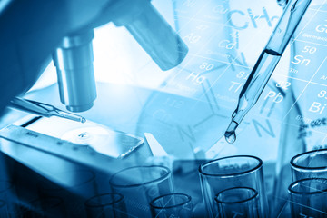 microscope and dropping chemical liquid to test tubes with lab glassware, science laboratory...