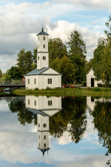 Obraz premium Old white watch tower building in summer evening sunlight