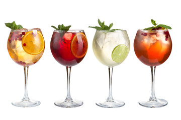Alcohol refreshing cocktails with mint, fruits and berries on a white background. A set of four cocktails in glass goblets.