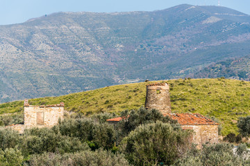 Fototapeta na wymiar Old Abandoned Windmill, Chapel and other Building in the Mountains of Southern Italy