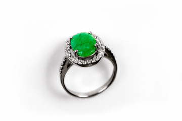 Luxury ring with green gem isolated on white background