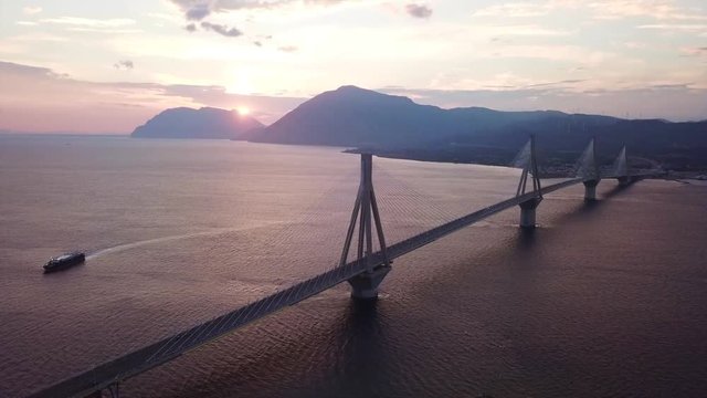 Aerial drone video of world famous cable suspension bridge of Rio - Antirio Harilaos Trikoupis, crossing Corinthian Gulf, mainland Greece to Peloponnese, Patras
