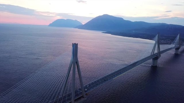 Aerial drone video of world famous cable suspension bridge of Rio - Antirio Harilaos Trikoupis, crossing Corinthian Gulf, mainland Greece to Peloponnese, Patras