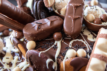 Beautiful homemade cake with chocolate, chocolate cookies and candies