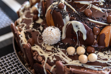 Beautiful homemade cake with chocolate, chocolate cookies and candies