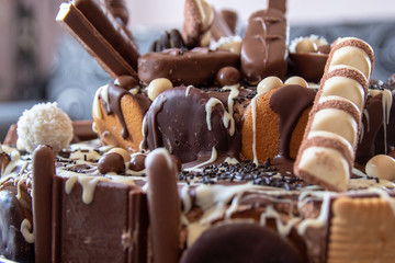 Beautiful homemade cake with chocolate, chocolate cookies and candies