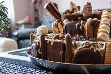 Beautiful homemade cake with chocolate, chocolate cookies and candies