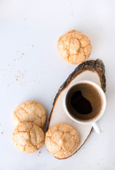 Cup of black coffee, a few shortbread cookies on a wooden cut