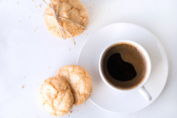Cup of black coffee, a few shortbread cookies on a white background,