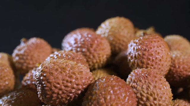Fruits of thai frkuta litchi on a black background.