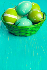 Green Easter eggs on wooden table