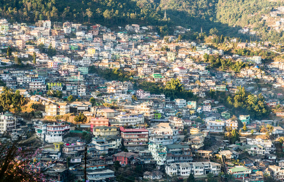 Cityscape with homes crowded along the hillside