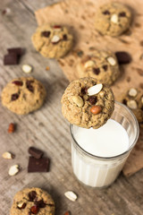 Homemade Oatmeal cookies with a glass of milk, photography in a rustic style, village and countryside wooden theme